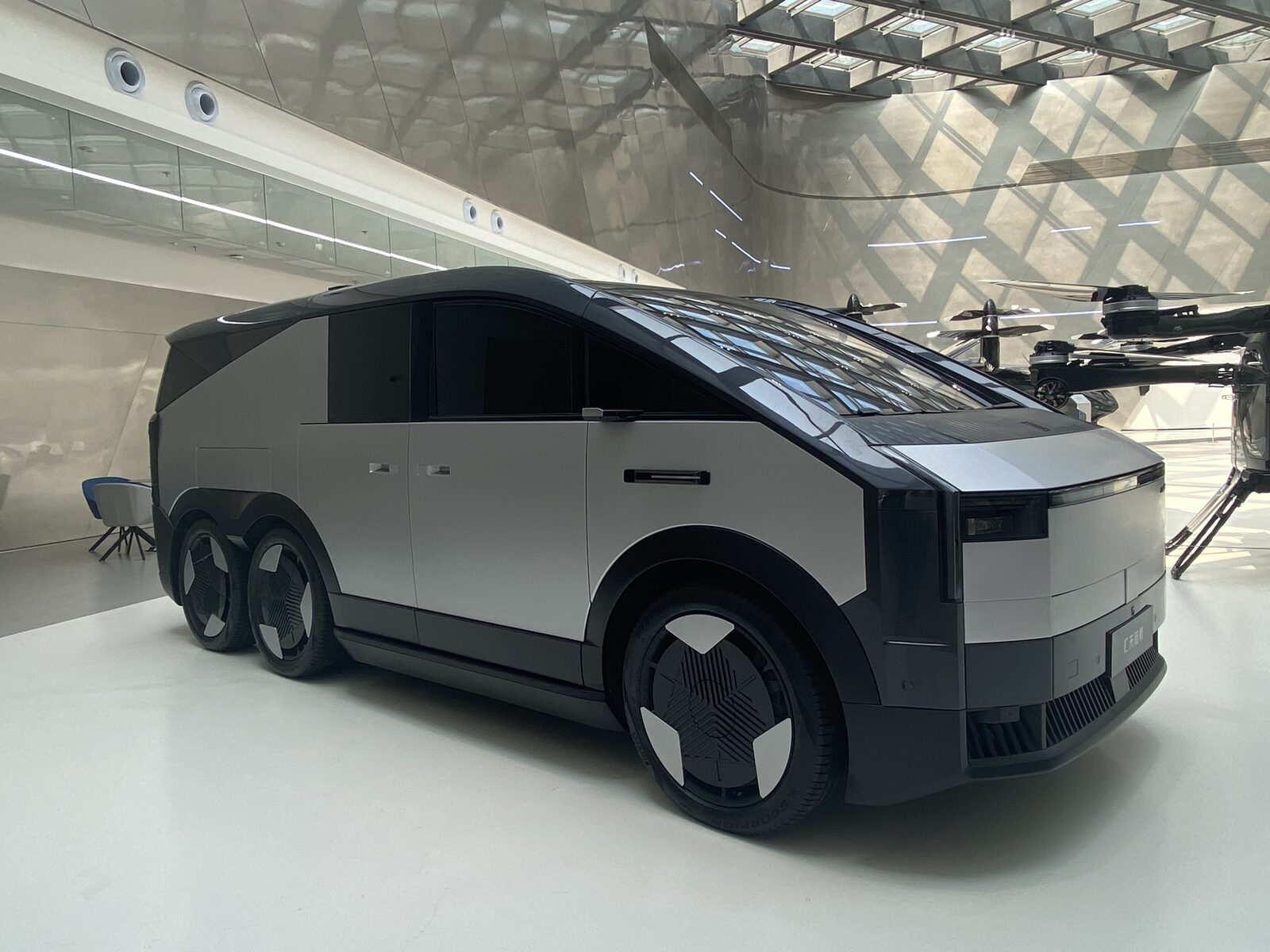 The Land Aircraft Carrier's six-wheeled electric mothership van, with the eVTOL aircraft visible behind it.